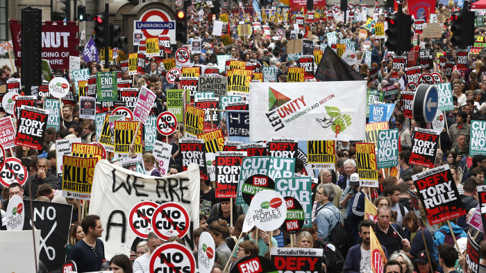 Demonstrators with placards crowd the area around the Bank of England as they gather for the start of a protest against the British government's spending cuts and austerity measures in London on June 20, 2015. The national demonstration against austerity was organised by People's Assembly against government spending cuts. AFP PHOTO / JUSTIN TALLIS (Photo credit should read JUSTIN TALLIS/AFP/Getty Images)