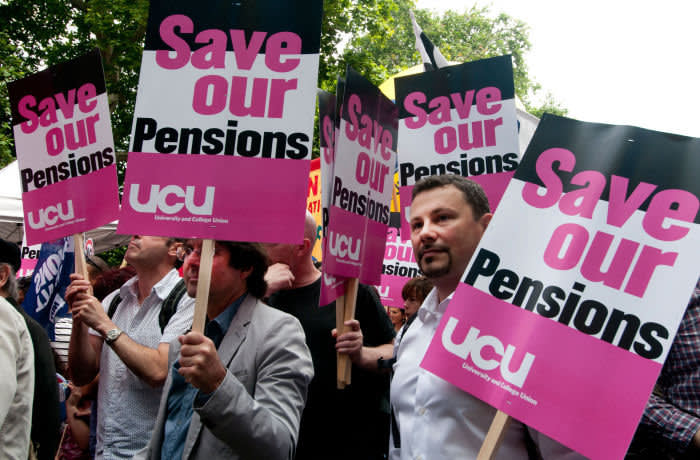 C50TRK One day strike by teachers and civil servants to protest at changes in pensions- group of members of UCU union with placards