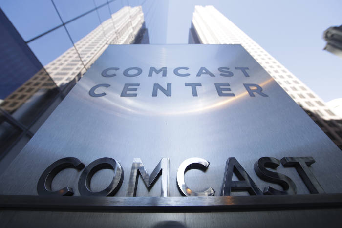 FILE - This March 29, 2017, file photo shows a sign outside the Comcast Center in Philadelphia. Comcast says it‚Äôs dropping out of the bidding war for Twenty-First Century Fox‚Äôs entertainment business, instead focusing on its bid for Sky. (AP Photo/Matt Rourke, File)