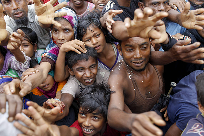 TOPSHOT - Rohingya refugees from Myanmar's Rakhine state wait for aid at Kutupalong refugee camp in the Bangladeshi town of Teknaf on September 5, 2017. Nearly 125,000 mostly Rohingya refugees have entered Bangladesh since a fresh upsurge of violence in Myanmar on August 25, the United Nations said September 5, as fears grow of a humanitarian crisis in the overstretched camps. The UN said 123,600 had crossed the border in the past 11 days from Myanmar's violence-wracked Rakhine state. / AFP PHOTO / K M AsadK M ASAD/AFP/Getty Images