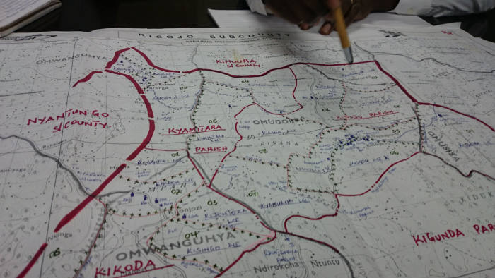 A hand-drawn map made by Uganda Bureau of Statistics (UBOS) which was used by local leaders of Aii-vu sub-county, Uganda, to confirm boundaries during the sub-county visits. As part of a project with the Ugandan government to improve refugee services, Humanitarian OpenStreetMap Team (HOT) in Uganda mapped areas first with satellite imagery, then with teams visiting the region (to verify and increase the details of the map). After the more detailed and accurate maps were completed, HOT gave the sub-county offices printed maps to work with. Credit: Humanitarian OpenStreetMap Team Uganda