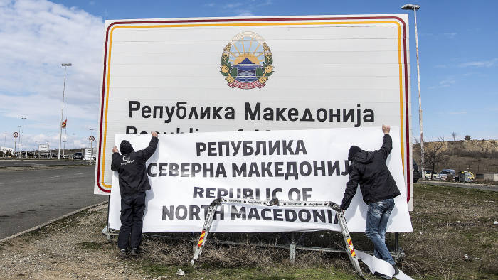 People are at work to change boards at the border between Macedonia and Greece near Gevgelija on February 13, 2019. - The deal between Skopje and Athens to rename Macedonia as North Macedonia came into force on February 12, 2019 after constitutional changes were published in the Official Gazette, the government said in a statement. Since 1991, Athens had objected to its neighbour being called Macedonia because Greece has a historic northern province of the same name. Greece has blocked Macedonia's NATO and EU integration until it changes the name. (Photo by Robert ATANASOVSKI / AFP) (Photo credit should read ROBERT ATANASOVSKI/AFP/Getty Images)