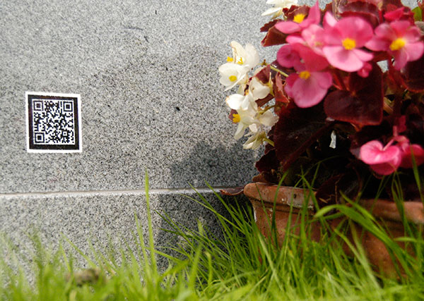 A gravestone with a ‘QR code’, which can be scanned to upload data about the deceased