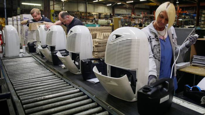 Employees assemble dehumidifiers on the production line at the Ebac Ltd. factory in Newton Aycliffe, U.K., on Monday, Jan. 9, 2017. The pound has weakened by more than 10 percent versus the euro since the referendum, making Ebac's water coolers and dehumidifiers cheaper abroad. Photographer: Matthew Lloyd/Bloomberg