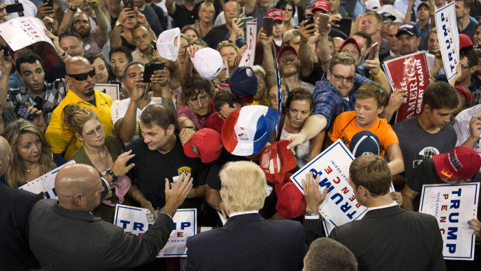 Donald Trump, 2016 Republican presidential nominee, center, greets attendees during a campaign rally at the Erie Insurance Arena in Erie, Pennsylvania