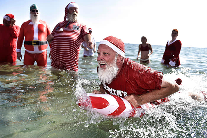 Actors dressed as Santa Claus take a refreshing bath at Bellevue Beach north of Copenhagen, Denmark, on July 24, 2018, as they take part in the World Santa Congress, an annual two-day event held every summer in Copenhagen. / AFP PHOTO / Ritzau Scanpix / Mads Claus Rasmussen / Denmark OUTMADS CLAUS RASMUSSEN/AFP/Getty Images