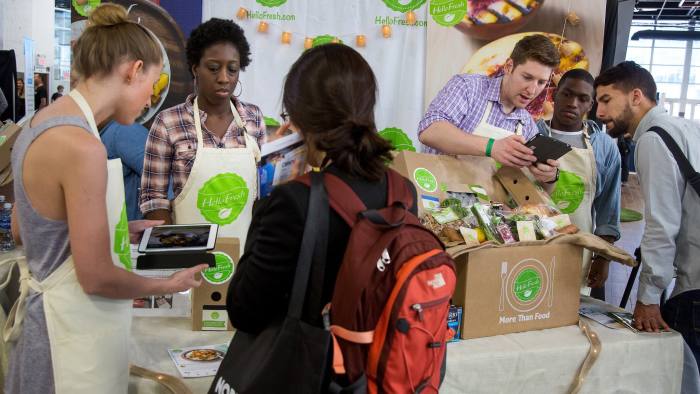 HelloFresh representatives sign up attendees with discounts for the company's meal delivery service during the Northside Innovation Expo at the Brooklyn Expo Center in the Brooklyn borough of New York, U.S., on Thursday, June 9, 2016. First-time jobless claims unexpectedly fell last week and the number of Americans already receiving benefits tumbled to an almost 16-year low, consistent with a healthy labor market. Photographer: Michael Nagle/Bloomberg