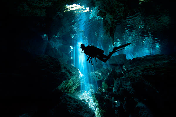 A diver in one of Tulum’s cenotes