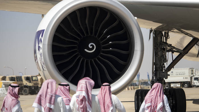 Visitors walks past the General Electric Co. GE90 jet engine of a Boeing Co. 777-368(ER) aircraft, operated by Saudi Arabian Airlines, on static display at the Saudi Air Show at Al Thumamah airport in Riyadh, Saudi Arabia, on Tuesday, March 12, 2019. Saudi Airshow is the first Aviation & Aerospace Exhibition of its kind in the Kingdom of Saudi Arabia. Photographer: Ryan Olson/Bloomberg