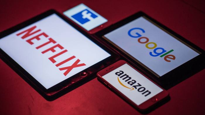 The logos for Facebook Inc., Amazon.com Inc., Netflix Inc. and Google, a unit of Alphabet Inc., sit on smartphone and tablet devices in this arranged photograph in London, U.K., on Monday, Aug. 20, 2018. The NYSE FANG+ Index is an equal-dollar weighted index designed to represent a segment of the technology and consumer discretionary sectors consisting of highly-traded growth stocks of technology and tech-enabled companies. Photographer: Jason Alden/Bloomberg