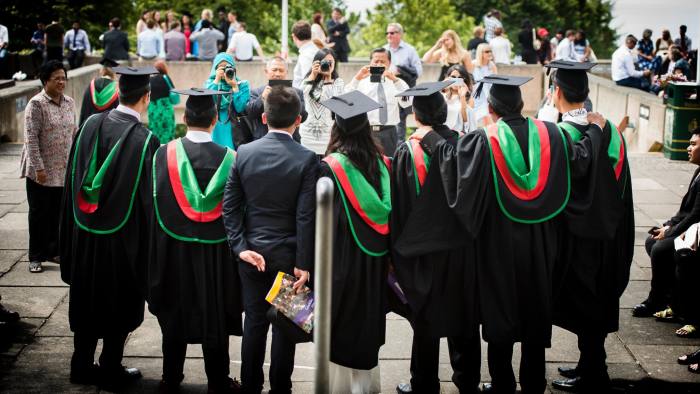 E8MD8B Parents photographing Students in their traditional gowns and mortar boards  graduating on graduation day Aberystwyth University
