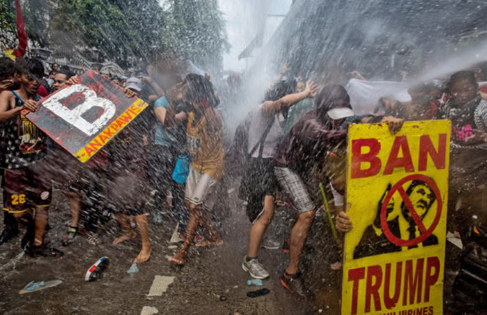 MANILA, PHILIPPINES - NOVEMBER 13: Protesters are soaked as they clash with riot police as they march the streets of Manila during the start of the ASEAN meetings between heads of state on November 13, 2017 in Manila, Philippines. Thousands of Filipinos protested in Manila as U.S. President Donald Trump's attended the ASEAN meetings in the Philippines, a stop included in his 12-day Asia trip. (Photo by Jes Aznar/Getty Images) ***BESTPIX***