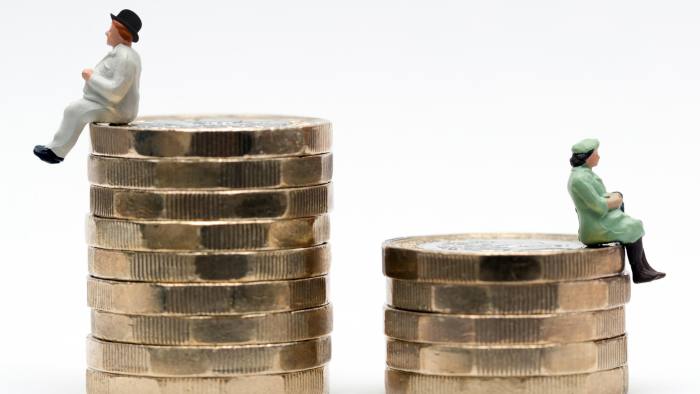 MA0PR0 Gender pay equality concept image of man and woman on a stack of pound coins