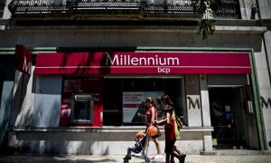 Pedestrians walk past a Portuguese Millennium BCP bank branch in Lisbon on August 7, 2014. BCP will refund prematurely 1.85 billion euros to the Portuguese State, which had granted a loan of 3 billion in June 2012, of which 400 million euros have already been reimbursed, the bank announced today. AFP PHOTO/ PATRICIA DE MELO MOREIRA (Photo credit should read PATRICIA DE MELO MOREIRA/AFP/Getty Images)