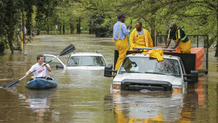 An Atlanta Public Works crew got caught in the Peachtree Creek overflow onto the flooded Woodward Way as they were delivering Road Block equipment and had to be rescued by the Atlanta Fire Rescue's Swift Water Dive Team in Atlanta, Wednesday, April 5, 2017. Severe storms raking the Southeast unleashed one large tornado and more than a half dozen apparent twisters Wednesday, toppling trees, roughing up South Carolina's &quot;peach capital&quot; and raining out golfers warming up for the Masters. (John Spink/Atlanta Journal-Constitution via AP)