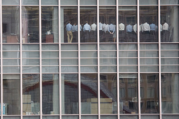 Staff stand in a meeting room at Lehman Brothers offices in the financial district of Canary Wharf in London September 11, 2008