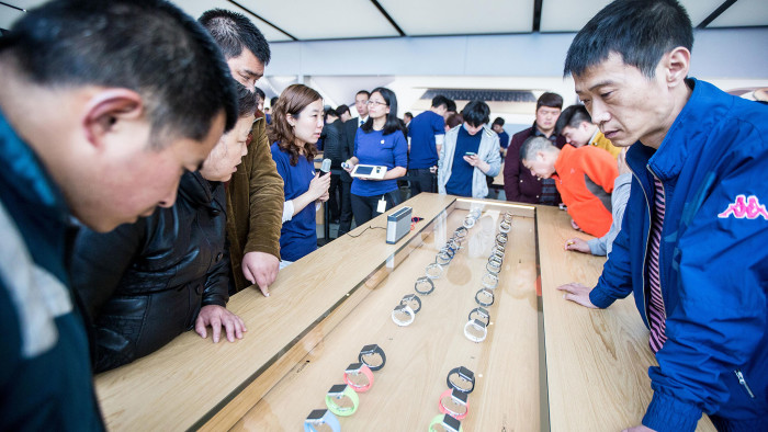 Customers look at Apple Inc. Apple Watch smartwatches displayed at an Apple Store near West Lake on April 10, 2015 in Hangzhou, Zhejiang province of China