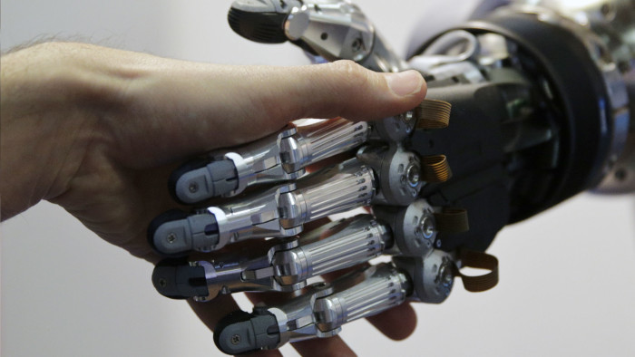A man shakes hands with a humanoid robot during the International Conference on Humanoid Robots in Madrid...A man shakes hands with a humanoid robot during the International Conference on Humanoid Robots in Madrid November 19, 2014.  REUTERS/Andrea Comas (SPAIN - Tags: SCIENCE TECHNOLOGY) - RTR4ER01