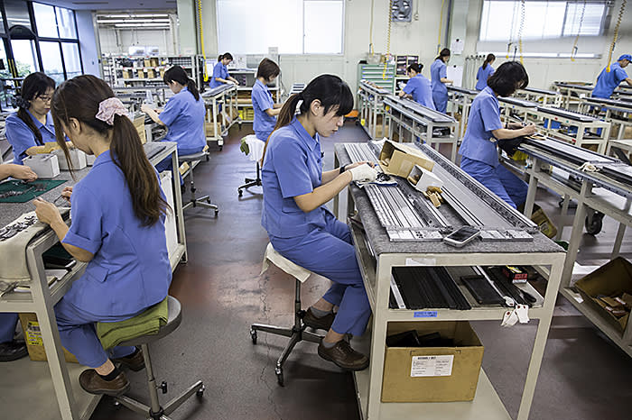 Employees assemble needles for knitting machines at the Shima Seiki Manufacturing Ltd. plant in Wakayama, Japan, on Tuesday, Sept. 12, 2017. Shima Seiki is one of the top global suppliers of advanced knitting machines, which create seamless and other clothing for brands from Prada and Giorgio Armani to Fast Retailing Co.’s Uniqlo. Photographer: Tomohiro Ohsumi/Bloomberg