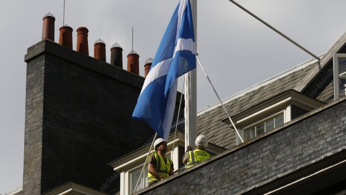 A Scottish Saltire flag is raised over 10 Downing Street in London September 9, 2014. The blue and white Scottish flag will be flown above British Prime Minister David Cameron's Downing Street office in the run-up to next week's referendum on independence, his spokesman said on Tuesday. The referendum on Scottish independence will take place on September 18, when Scotland will vote whether or not to end the 307-year-old union with the rest of the United Kingdom. REUTERS/Luke MacGregor (BRITAIN - Tags: POLITICS ELECTIONS)