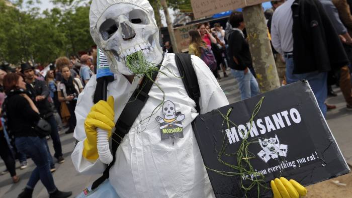 A protester wearing a chemical protection takes part in a March Against Monsanto at Place de la Republique in Paris, Saturday, May 21, 2016. European Union countries on Thursday again delayed a vote on whether to renew the sales authorization of glyphosate, the active ingredient in Monsanto's popular herbicide Roundup, amid conflicting scientific assessments on whether the substance causes cancer in humans. (AP Photo/Francois Mori)