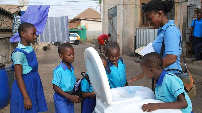 The Ideo sanitation project being explained to children in Kumasi, Ghana