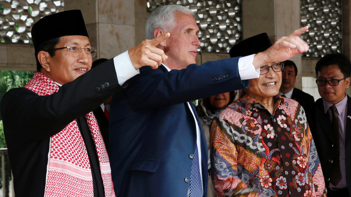 US Vice President Mike Pence (C), accompanied by High Priest Nasaruddin Umar (L) and Chairman of the Istiqlal Mosque Management Executive Board Muhammad Muzammil Basyuni (R), gestures during his visit to the Istiqlal Mosque in Jakarta on April 20, 2017. US Vice President Mike Pence on April 20 praised Indonesia's moderate form of Islam as &quot;an inspiration&quot; at the start of a visit to the Muslim-majority country seen as a bid by his administration to heal divisions with the Islamic world. / AFP PHOTO / POOL / Adi WEDAADI WEDA/AFP/Getty Images