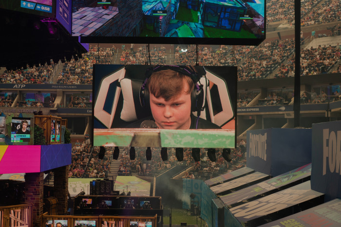 BenjyFishy, a British 'Fortnite' player who commands 200,000 followers on the streaming platform Twitch, is displayed on the big screen. Photographed for the FT by Patrick Driscoll