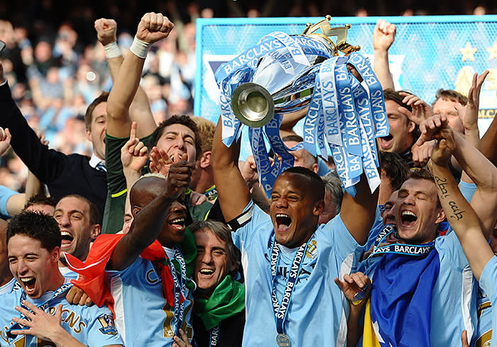 Manchester City's Belgian captain Vincent Kompany lifts the Premier league trophy after their 3-2 victory over Queens Park Rangers in the English Premier League football match between Manchester City and Queens Park Rangers at The Etihad stadium in Manchester, north-west England on May 13, 2012. Manchester City won the game 3-2 to secure their first title since 1968. This is the first time that the Premier league title has been decided on goal-difference, Manchester City and Manchester United both finishing on 89 points. AFP PHOTO/PAUL ELLIS RESTRICTED TO EDITORIAL USE. No use with unauthorized audio, video, data, fixture lists, club/league logos or 'live' services. Online in-match use limited to 45 images, no video emulation. No use in betting, games or single club/league/player publications. (Photo credit should read PAUL ELLIS/AFP/GettyImages)
