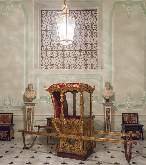 An 18th-century, gold sedan chair that pop star Madonna loves to sit in whenever she visits