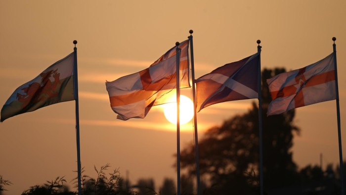 GRETNA GREEN, SCOTLAND - SEPTEMBER 16: The sun sets behind the flags of the Union countries of the United Kingdom on September 16, 2014 in Gretna Green, Scotland. Yes and No supporters are campaigning in the last two days of the referendum to decide if Scotland will become an indpendent country. (Photo by Peter Macdiarmid/Getty Images)