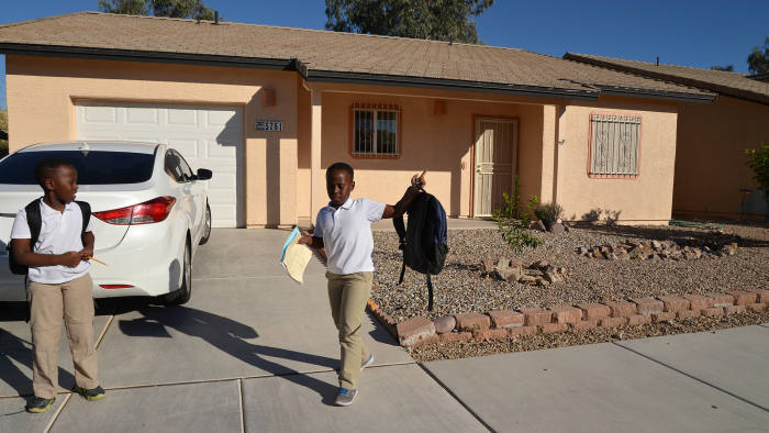Tucson, Arizona, USA; November 1, 2018; Samuel Tabaruks, 8, (left), and his twin brother, Salamon, 8, arrive home after a day at school to their home built through Habitat for Humanity on Tucson's south side. Credit: Norma Jean Gargasz