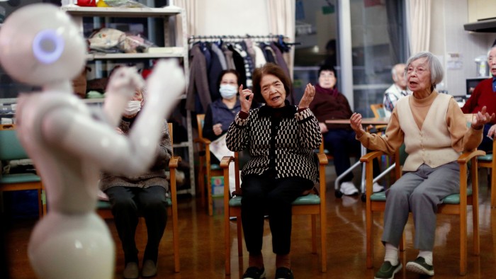 Residents follow moves made by humanoid robot 'Pepper' during an afternoon exercise routine at Shin-tomi nursing home in Tokyo, Japan, February 2, 2018. REUTERS/Kim Kyung-Hoon SEARCH &quot;KYUNG-HOON ROBOTS&quot; FOR THIS STORY. SEARCH &quot;WIDER IMAGE&quot; FOR ALL STORIES. - RC1C10C49A70