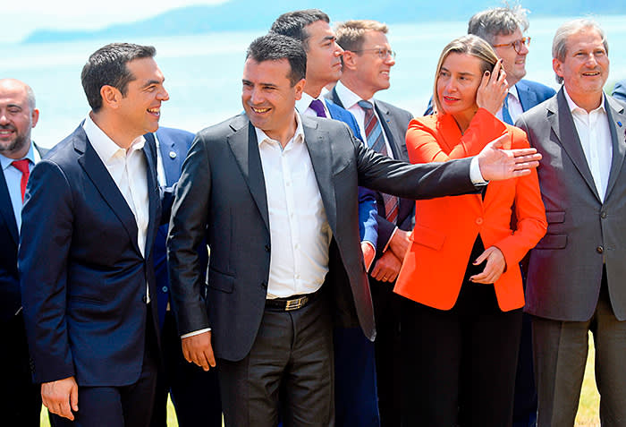 Macedonian Prime Minister Zoran Zaev (2ndL) welcomes Greek Prime Minister Alexis Tsipras (L), High Representative of the European Union for Foreign Affairs and Security Policy Federica Mogherini (2ndR) and European Commissioner for European Neighbourhood Policy and Enlargement Negotiations Johannes Hahn (R) on the shore of the Lake Prespa near Otesevo on June 17, 2018. - The foreign ministers of Greece and Macedonia signed a historic preliminary accord to end a 27-year bilateral row by renaming Macedonia to Republic of North Macedonia. (Photo by Maja ZLATEVSKA / AFP) (Photo credit should read MAJA ZLATEVSKA/AFP/Getty Images)