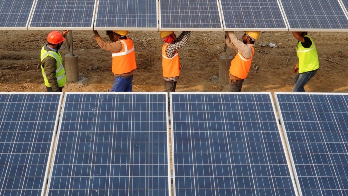 Indian workers construct part of the France-India Solar Direct Punjab Solar Park project in Muradwala 