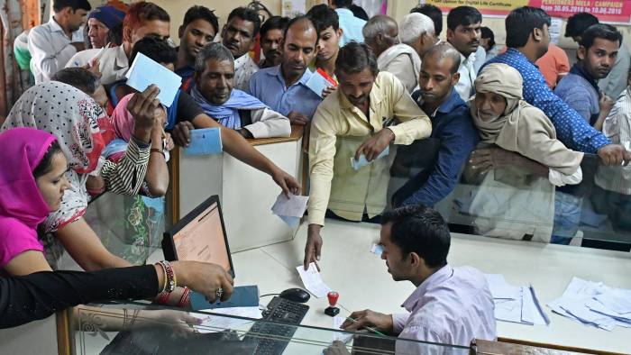 Customers wait to exchange Indian five hundred and one thousand rupee banknotes at a Syndicate Bank branch in Dadri, Uttar Pradesh, India, on Tuesday, Nov. 15, 2016. Over a week since Prime Minister Narendra Modi shocked the nation with the withdrawal of large denomination notes there was no sign the government had managed to print enough notes to replace its withdrawal of 86 per cent of currency in circulation. Photographer: Anindito Mukherjee/Bloomberg
