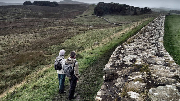 Hikers near the Roman fort at Housesteads