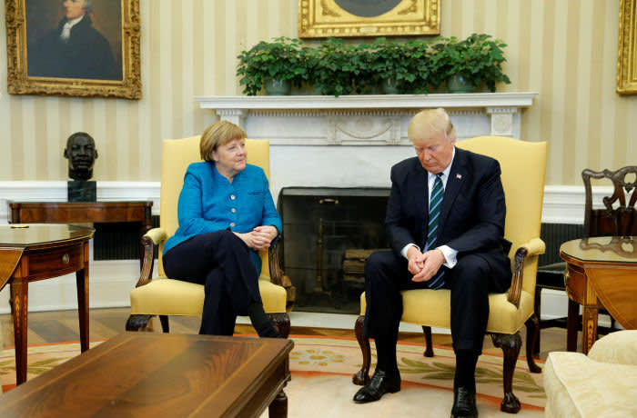 U.S. President Donald Trump and Germany's Chancellor Angela Merkel wait for reporters to enter the room before their meeting in the Oval Office at the White House in Washington, U.S. March 17, 2017. REUTERS/Jonathan Ernst - RTX31I6H