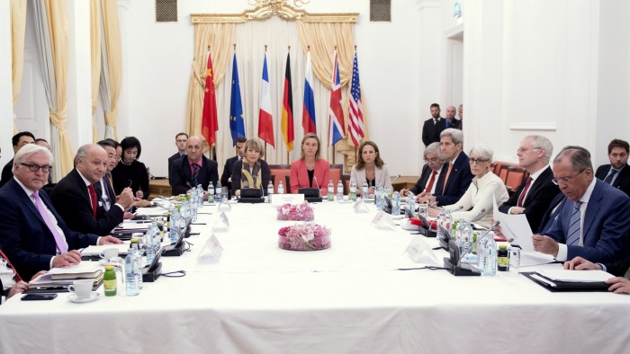 German Foreign Minister Frank-Walter Steinmeier (L), French Foreign Minister Laurent Fabius (2nd L), Chinese Foreign Minister Wang Yi (3rd L), European Union foreign policy chief Federica Mogherini (Centre in red), U.S. Secretary of State John Kerry (4th R) and Russian Foreign Minister Sergei Lavrov (R) meet at a hotel in Vienna July 13, 2015. Iran and six world powers were close to clinching an historic pact on Monday that would bring Iran sanctions relief in exchange for curbs on its nuclear programme, but an Iranian negotiator said he could not guarantee a deal was imminent. AFP PHOTO/ JOE KLAMAR