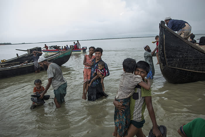 DAKHINPARA, BANGLADESH - SEPTEMBER 08: Rohingya refugees arrive on wooden boats after travelling from Myanmar, on September 08, 2017 in Dakhinpara, Bangladesh. Recent reports have suggested that around 290,000 Rohingya have now fled Myanmar after violence erupted in Rakhine state. The 'Muslim insurgents of the Arakan Rohingya Salvation Army' have issued statement that indicates that they are to observe a cease fire, and have asked the Myanmar government to reciprocate. (Photo by Dan Kitwood/Getty Images)