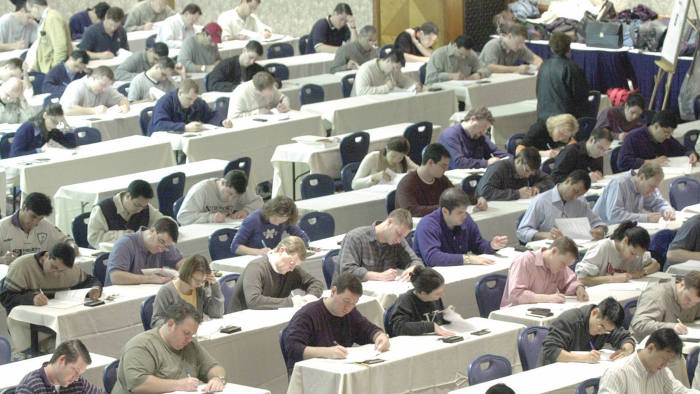 Candidates completing a Chartered Financial Analyst (CFA) exam