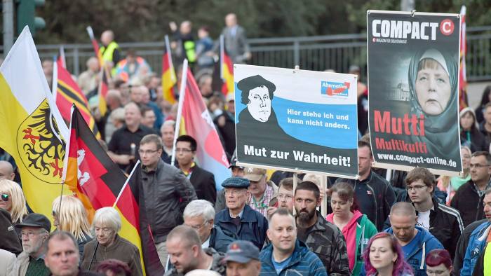 epa05550987 Participants march with banners and placards during the Alternative for Germany (AfD) party rally tittled 'protect borders, provide social security', in Erfurt, Germany, 21 September 2016. After kicking off the rally at the main station, the demonstrators moved with around 1,500 participants to the Thuringian state parliament. EPA/MARTIN SCHUTT