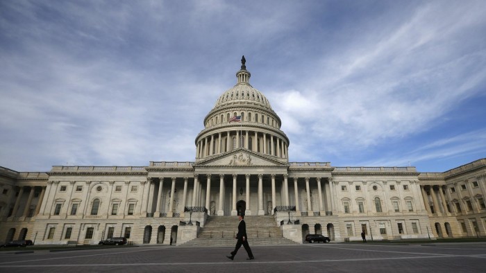 A lone worker passes by the U.S. Capitol Building in Washington, October 8, 2013. A few faint glimmers of hope surfaced in the U.S. fiscal standoff, both in Congress and at the White House, with President Barack Obama saying he would accept a short-term increase in the nation's borrowing authority to avoid a default. REUTERS/Jason Reed (UNITED STATES - Tags: POLITICS)