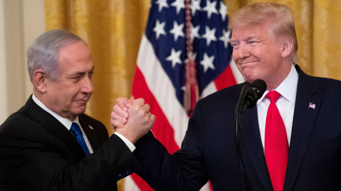 Mandatory Credit: Photo by MICHAEL REYNOLDS/EPA-EFE/Shutterstock (10541711a) US President Donald J. Trump (R) shakes hands with Prime Minister of Israel Benjamin Netanyahu while unveiling his Middle East peace plan in the East Room of the White House, in Washington, DC, USA, 28 January 2020. US President Donald J. Trump's Middle East peace plan is expected to be rejected by Palestinian leaders, having withdrawn from engagement with the White House after Trump recognized Jerusalem as the capital of Israel. The proposal was announced while Netanyahu and his political rival, Benny Gantz, both visit Washington, DC. US President Donald J. Trump unveils his Middle East peace plan alongside Prime Minister of Israel Benjamin Netanyahu, Washington, USA - 28 Jan 2020