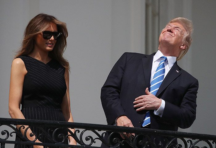 WASHINGTON, DC - AUGUST 21: (AFP OUT) U.S. President Donald Trump looks up toward the Solar Eclipse while joined by his wife first lady Melania Trump on the Truman Balcony at the White House on August 21, 2017 in Washington, DC. Millions of people have flocked to areas of the U.S. that are in the &quot;path of totality&quot; in order to experience a total solar eclipse. (Photo by Mark Wilson/Getty Images)