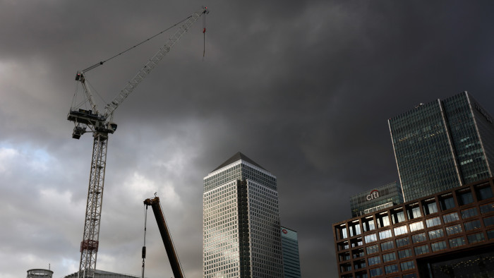 Dark clouds form above construction cranes in front of No. 1 Canada Square, center, at the Canary Wharf financial, shopping and business district in London, U.K., on Tuesday, June 21, 2016. Financial and related services accounted for 11.8 percent of U.K. economic output, or 190 billion pounds ($278 billion), in 2014, and quitting the EU could cost as many as 100,000 jobs in the sector by 2020, according to industry group TheCityUK. Photographer: Simon Dawson/Bloomberg