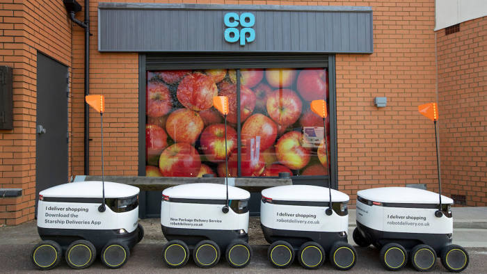 Co Op Opening Emerson Valley Milton Keynes with Delivery Robots and children from Howe Park School help with ribbon cutting.