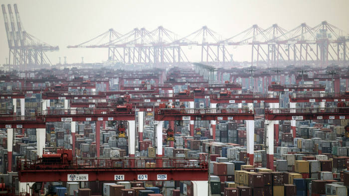 Gantry cranes stand as shipping containers sit stacked at the Yangshan Deepwater Port, operated by Shanghai International Port Group Co. (SIPG), in Shanghai, China, on Friday, May 10, 2019. The U.S. hiked tariffs on more than $200 billion in goods from China on Friday in the most dramatic step yet of President Donald Trump's push to extract trade concessions, deepening a conflict that has roiled financial markets and cast a shadow over the global economy. Photographer: Qilai Shen/Bloomberg