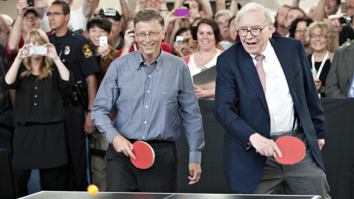 Warren Buffett, chairman of Berkshire Hathaway Inc., right, and Bill Gates, chairman of Microsoft Corp., play table tennis during an event at the annual shareholders meeting in Omaha, Nebraska, U.S., on Sunday, May 6, 2012. Berkshire Hathaway Inc. investment managers Todd Combs and Ted Weschler receive $1 million salaries and can earn more if their bets beat the Standard & Poor's 500 Index, Buffett said Sunday. Photographer: Daniel Acker/Bloomberg *** Local Caption *** Warren Buffett; Bill Gates