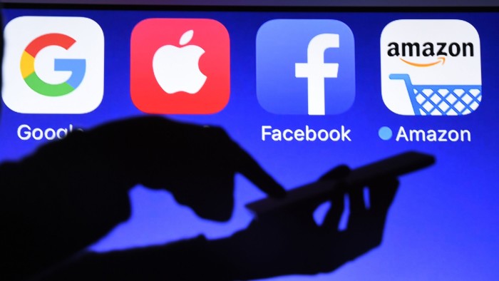 This photograph taken on September 28, 2017, shows a smartphone being operated in front of GAFA logos (acronym for Google, Apple, Facebook and Amazon web giants) as background in Hédé-Bazouges, western France. / AFP PHOTO / Damien MEYER (Photo credit should read DAMIEN MEYER/AFP/Getty Images)